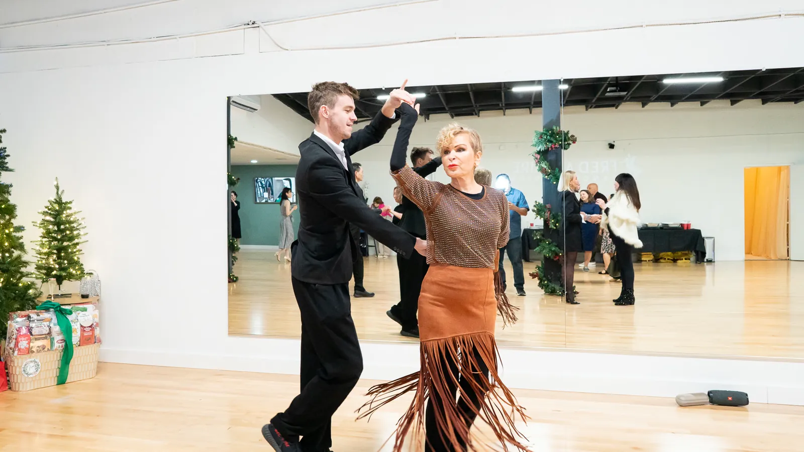 A student practices a Latin dance turn with an instructor at Fred Astaire Dance Studios Alhambra.